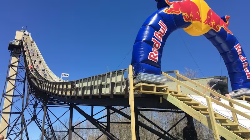 Competitors climbing the Copper Peak ski jump during the Red Bull 400