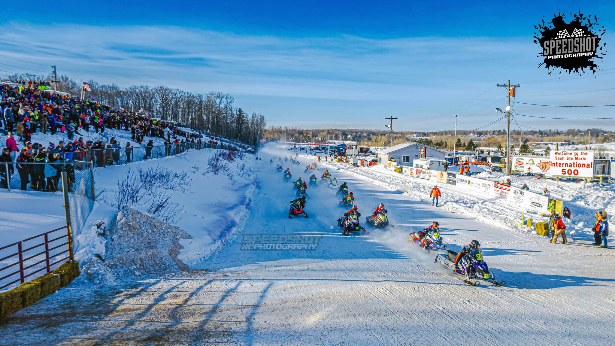 International 500 snowmobile endurance racers competing on the oval ice track