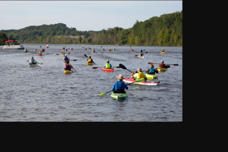 Paddlers kayaking on the Chain of Lakes Water Trail during the Paddle Antrim Festival