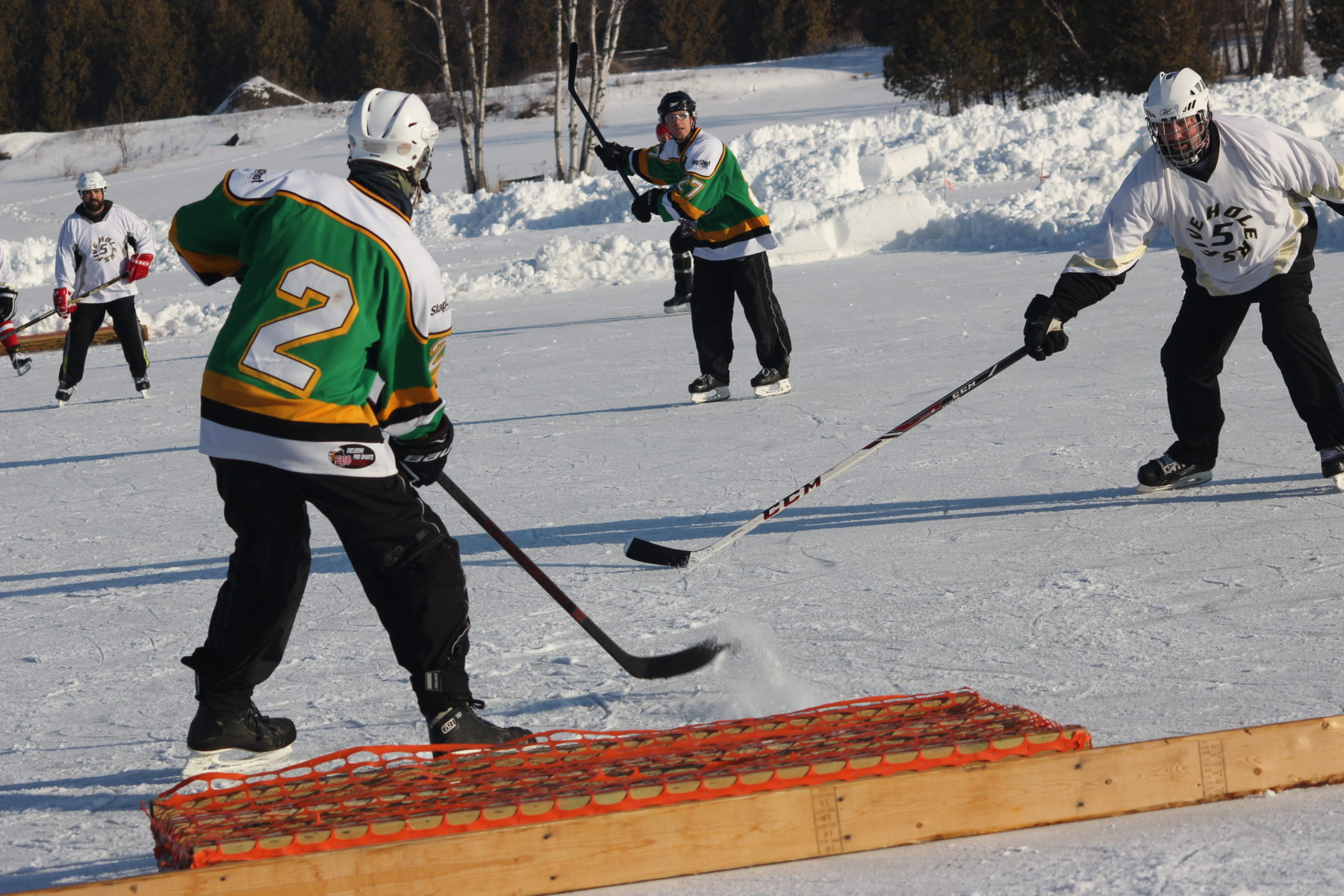 Players competing on the outdoor ice during the U.P. Pond Hockey Championship